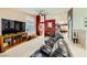 Spacious living room with tile flooring, a large TV, and an adjacent dining area at 1905 Dakota Hills Ave, Las Vegas, NV 89123