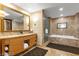 Luxurious bathroom with double vanity, marble finishes, a soaking tub, and a separate glass shower at 2000 N Fashion Show Dr # 5326, Las Vegas, NV 89109