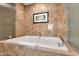 Close-up of a soaking tub with marble tile surround, perfect for relaxation and unwinding at 2000 N Fashion Show Dr # 5326, Las Vegas, NV 89109