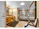 Spacious bathroom featuring double vanity, a separate tub and shower, and decorative mirror at 2000 N Fashion Show Dr # 5326, Las Vegas, NV 89109