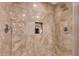 Luxurious bathroom featuring marble tile, rain shower head, and built-in shelving niche at 2000 N Fashion Show Dr # 5326, Las Vegas, NV 89109