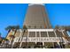 A towering view of the Trump International building with lush landscaping and clear blue skies at 2000 N Fashion Show Dr # 5326, Las Vegas, NV 89109