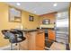 Modern kitchenette has stainless steel appliances, dark countertops, and breakfast bar at 2000 N Fashion Show Dr # 5326, Las Vegas, NV 89109