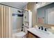 Well-lit bathroom with shower-tub combo and cabinet with sink at 2028 Bavington Dr # A, Las Vegas, NV 89108