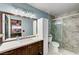 Bright bathroom featuring a large mirror, vanity, and a glass-enclosed shower with marbled tile at 2028 Bavington Dr # A, Las Vegas, NV 89108