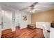 Bright bedroom featuring wood floors, a ceiling fan, and ample storage at 2028 Bavington Dr # A, Las Vegas, NV 89108