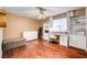 Bedroom with ceiling fan, wood floors, storage shelves, and desk at 2028 Bavington Dr # A, Las Vegas, NV 89108