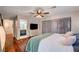 Bedroom with wood floors, ceiling fan, closet, and view into ensuite bathroom at 2028 Bavington Dr # A, Las Vegas, NV 89108
