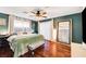 Inviting bedroom with wood floors, ceiling fan, and a large window offering ample natural light at 2028 Bavington Dr # A, Las Vegas, NV 89108