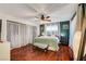 Comfortable bedroom featuring dark wood floors, a ceiling fan, and plenty of natural light at 2028 Bavington Dr # A, Las Vegas, NV 89108