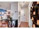 Inviting hallway with wood floors, cabinet, and decor leading to the dining area at 2028 Bavington Dr # A, Las Vegas, NV 89108