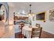 Cozy kitchen and dining area featuring stainless steel appliances, granite countertops, and a round table for casual meals at 2028 Bavington Dr # A, Las Vegas, NV 89108