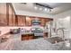 Spacious kitchen with granite countertops, stainless steel appliances, and an adjacent laundry area at 2028 Bavington Dr # A, Las Vegas, NV 89108