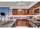 Well-lit kitchen featuring granite countertops, modern appliances, and dark wood cabinetry at 2028 Bavington Dr # A, Las Vegas, NV 89108
