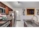 Open kitchen with stainless steel appliances, granite countertops, and easy access to the laundry room at 2028 Bavington Dr # A, Las Vegas, NV 89108