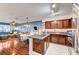 Open-concept kitchen flows into the living area, featuring stainless steel appliances and granite countertops, ideal for modern living at 2028 Bavington Dr # A, Las Vegas, NV 89108