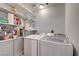 Laundry room with stacked shelves and side-by-side washer and dryer at 2028 Bavington Dr # A, Las Vegas, NV 89108