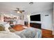 Open-concept living room features a ceiling fan, hardwood floors, and large sectional sofa, leading into the kitchen at 2028 Bavington Dr # A, Las Vegas, NV 89108