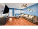 Bright living room with blue wall, large window, comfortable sectional sofa, modern decor, and wood look floors at 2028 Bavington Dr # A, Las Vegas, NV 89108