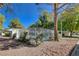 Community pool area enclosed by white fencing, surrounded by mature trees, and with chairs for resident's enjoyment at 2028 Bavington Dr # A, Las Vegas, NV 89108