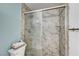 Modern shower with sliding glass door and marbled tile at 2028 Bavington Dr # A, Las Vegas, NV 89108