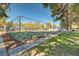 Outdoor tennis court enclosed with fencing with a sidewalk alongside at 2028 Bavington Dr # A, Las Vegas, NV 89108