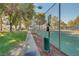 Outdoor tennis court with a sidewalk and pet waste station at 2028 Bavington Dr # A, Las Vegas, NV 89108