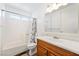 Clean bathroom with a shower-tub combo, bright lighting, and a wood vanity at 2440 Homestead Rd, Pahrump, NV 89048