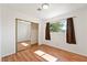 Bright bedroom with a large mirrored closet, wood floors, and a window providing natural light at 2440 Homestead Rd, Pahrump, NV 89048
