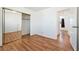 Bedroom with wood floors, mirrored closet, and neutral walls at 2440 Homestead Rd, Pahrump, NV 89048