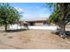 Charming single-story home with a spacious front yard, mature trees, and a welcoming curb appeal at 2440 Homestead Rd, Pahrump, NV 89048