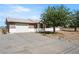 Single-story home with a front-facing garage and low maintenance landscaping, offering practical living at 2440 Homestead Rd, Pahrump, NV 89048