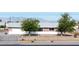 Single story home with a fenced front yard and two mature trees providing shade at 2440 Homestead Rd, Pahrump, NV 89048