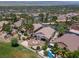 Aerial view of lush community with mature palm trees, homes, pool, and desert landscape at 2505 Links Dr, Laughlin, NV 89029