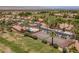 Aerial view of homes featuring a tennis court, greenbelt, and mature palm trees at 2505 Links Dr, Laughlin, NV 89029