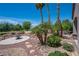Lush backyard showcasing desert landscaping, fire pit, and covered patio at 2505 Links Dr, Laughlin, NV 89029