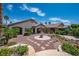 Beautifully landscaped backyard with covered patio and designated fire pit area at 2505 Links Dr, Laughlin, NV 89029