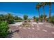 Lush backyard with desert landscaping, a rock water feature, and a manicured lawn at 2505 Links Dr, Laughlin, NV 89029