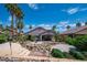 Stunning backyard features rock waterfall, palm trees, and mature landscaping at 2505 Links Dr, Laughlin, NV 89029