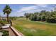 Peaceful backyard with rock waterfall, lush green grass, and views of the golf course at 2505 Links Dr, Laughlin, NV 89029
