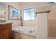 Bright bathroom features a large tub with granite surround and window at 2505 Links Dr, Laughlin, NV 89029