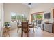 Bright dining area featuring a round table, four chairs, and a sliding glass door leading to the backyard at 2505 Links Dr, Laughlin, NV 89029
