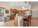 Cozy kitchen featuring wood cabinets, stainless steel appliances, and granite countertops with breakfast bar at 2505 Links Dr, Laughlin, NV 89029