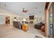 Bright living room with a fireplace, ceiling fan, and views into other living spaces at 2505 Links Dr, Laughlin, NV 89029