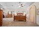 Large main bedroom featuring an arched entrance, ceiling fan, and carpeted floors at 2505 Links Dr, Laughlin, NV 89029