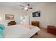 Bedroom with TV, ceiling fan, and doorway to a bathroom at 2505 Links Dr, Laughlin, NV 89029