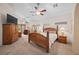 Large main bedroom featuring carpeted floors, ceiling fan, and sitting area at 2505 Links Dr, Laughlin, NV 89029