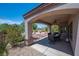 Charming covered patio overlooking beautifully landscaped backyard with a fire pit at 2505 Links Dr, Laughlin, NV 89029