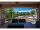 Covered patio offering beautiful backyard views of desert landscaping and mature trees at 2505 Links Dr, Laughlin, NV 89029