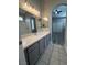 Bathroom with gray cabinets, white counter tops leading to bedroom at 2694 Hillgrass Rd, Las Vegas, NV 89123